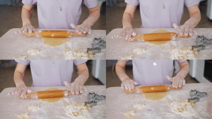 在家用木针烹饪饼干固定面团的女性双手特写