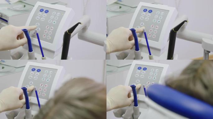 患者使用现代牙科设备的牙医