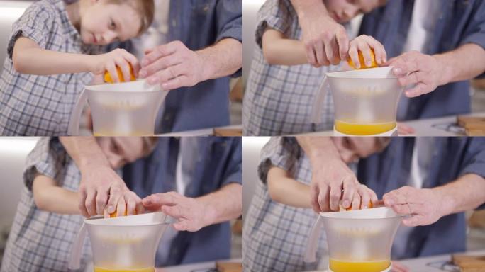 父亲帮助男孩制作新鲜的橙汁