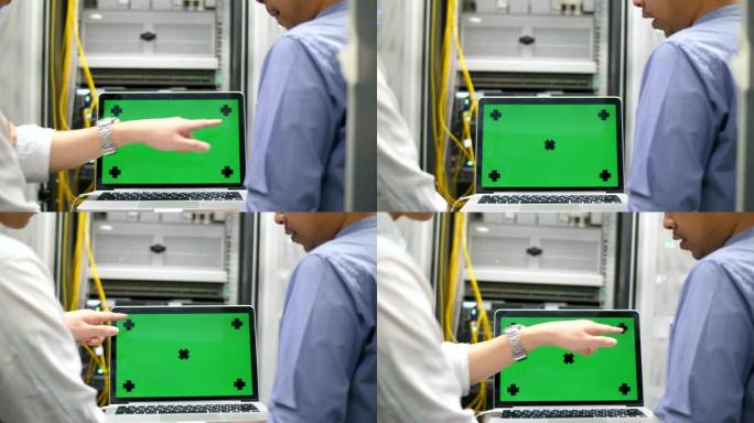 工程师拿着带绿屏色度键的笔记本电脑