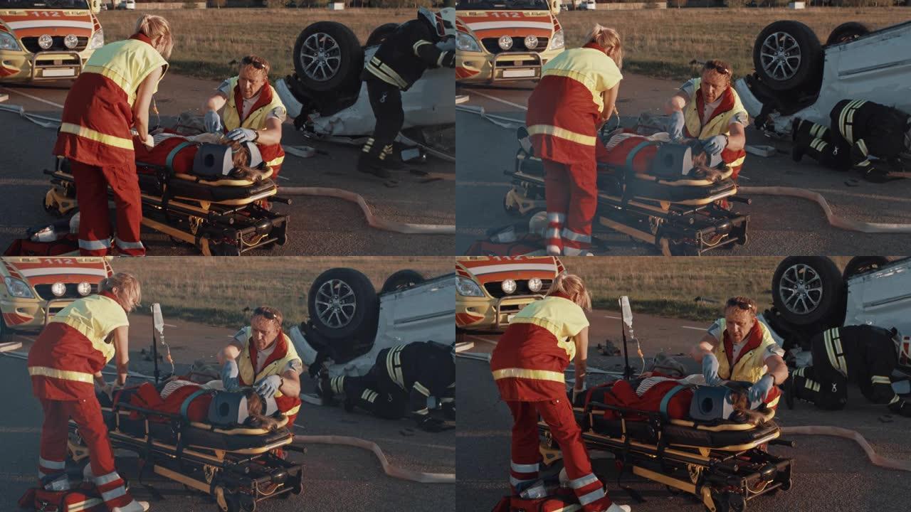 在车祸交通事故现场: 医护人员挽救了躺在担架上的女性受害者的生命。他们使用氧气面罩，进行心肺复苏/C