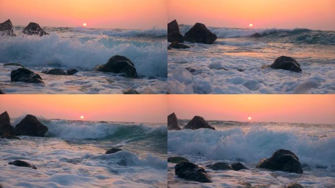 日落时海浪冲向石头
