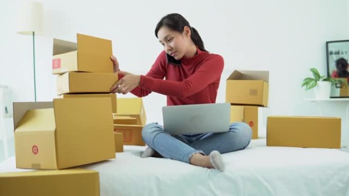 年轻的女企业家在自己的工作中数邮包箱在家购物在线业务