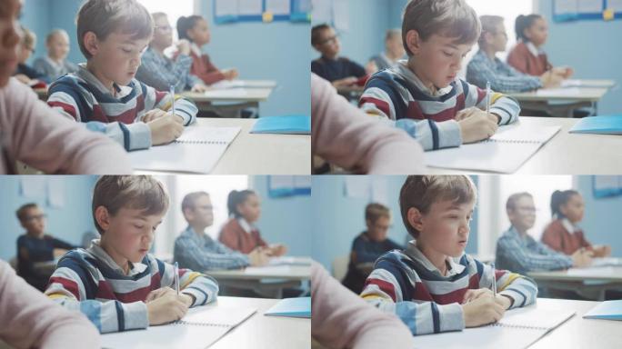 在小学课堂上: 才华横溢的高加索男孩的肖像在练习笔记本上写作，参加考试和写作考试。多元化的聪明孩子勤