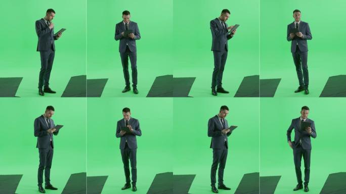 二合一分割绿屏拼贴: 穿着西装的英俊商人使用数字平板电脑站立。两个分屏色度键背景蒙太奇的前半侧视图