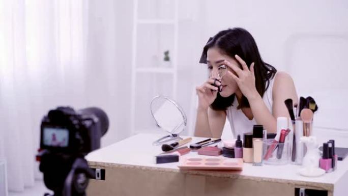 4K分辨率亚洲女性美容博主，v-logger应用睫毛夹在她的眼睛做化妆品化妆教程