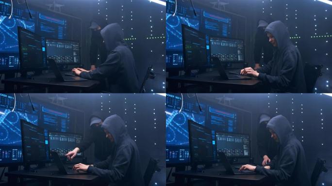 年轻的黑客，穿着黑衣服在电脑前工作。他们决定如何最好地侵入政府服务器并运行病毒程序。