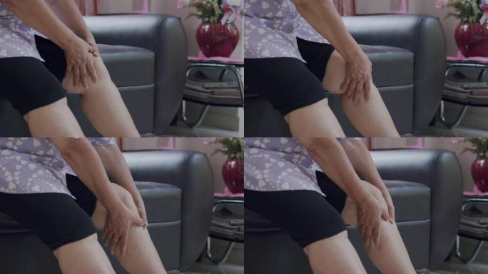 4k分辨率亚洲高级女性用手按摩腿部疼痛。保健概念。特写镜头。