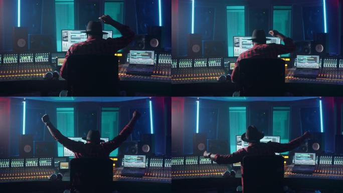艺术家，音乐家，音频工程师，音乐唱片工作室的制作人，使用带有计算机屏幕的控制台，显示带有歌曲播放的软