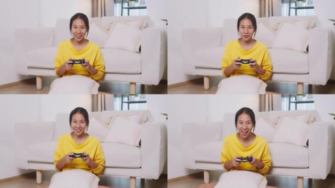美丽的亚洲女人在客厅玩游戏的观点