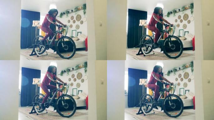 在家运动，在家健身的概念。锁定期间非洲女士的骑自行车练习