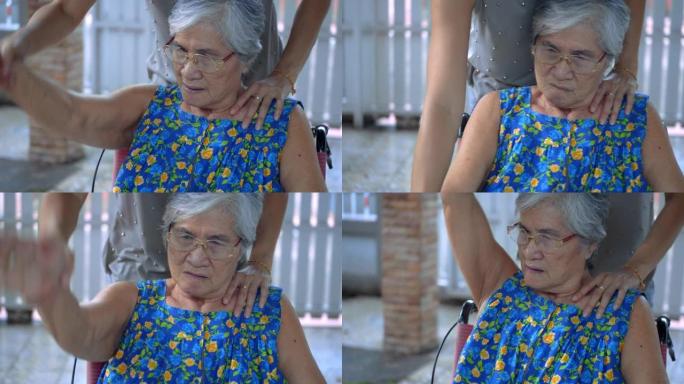 护理人员协助老年妇女进行手部锻炼，慢动作