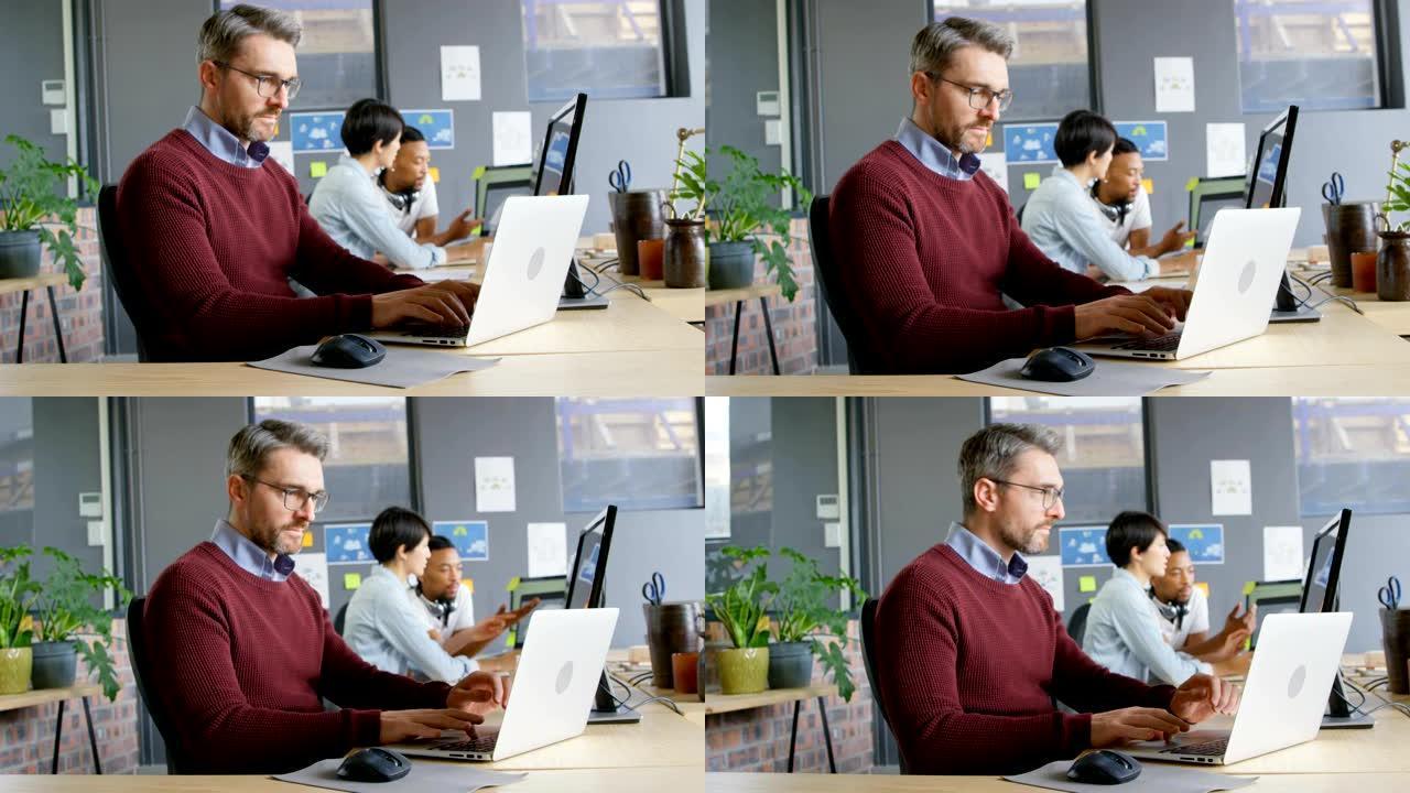 细心的男性高管在办公室使用笔记本电脑4k