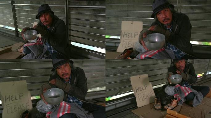 可怜的无家可归者或难民坐在城市街道的地板上，社会纪录片概念，
