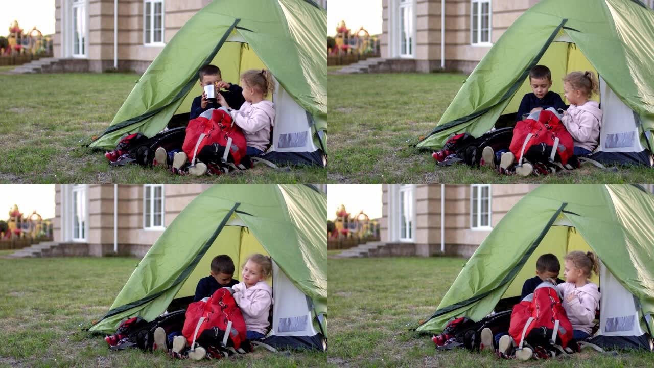青春期前的高加索男孩和女孩在后院玩露营游戏