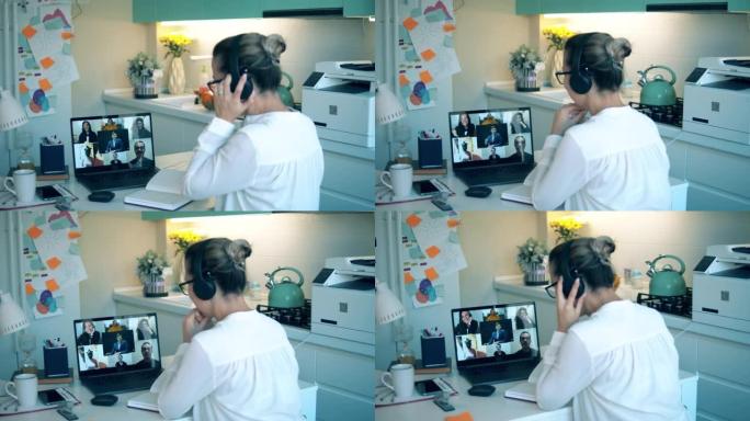 一个自我隔离的女人正在参加一个电话会议。视频会议的概念。