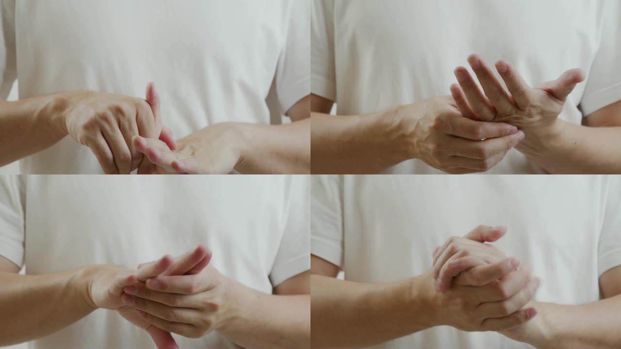 穿着白衬衫的亚洲男人感到手指疼痛。肌肉疼痛，保健概念。