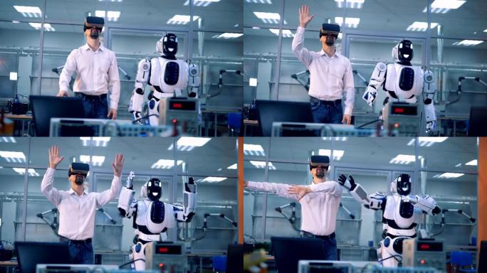 男工人和机器人用手臂做动作。虚拟现实游戏。