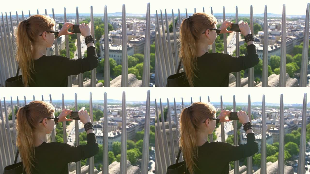 巴黎的女人在温暖阳光明媚的夏日从上方拍摄城市的照片