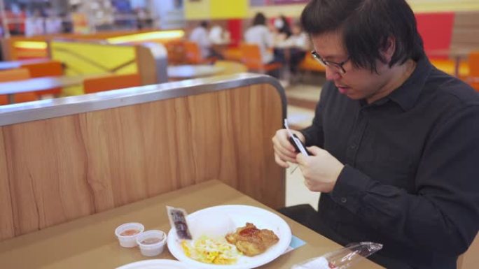 4k新正常饮食。亚洲男子在餐厅吃午饭前脱下口罩