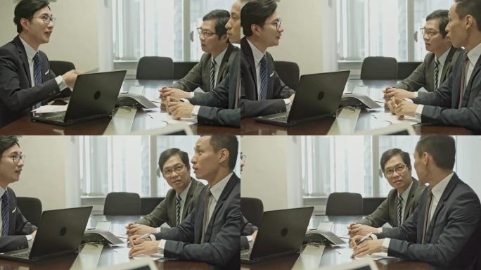 平移中国商人在办公室会议上讲话的视频