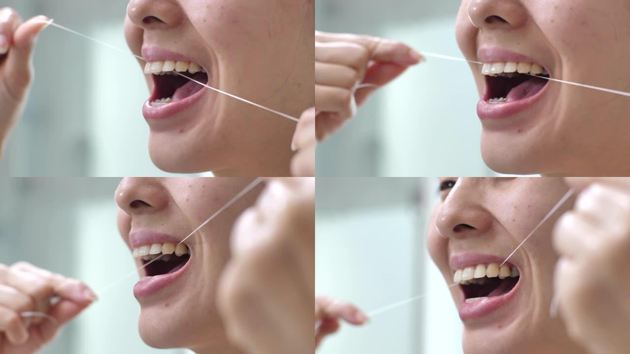 亚洲妇女在浴室使用牙线