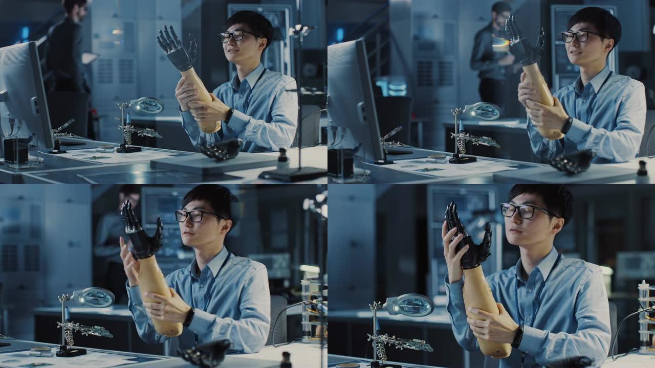 未来的假肢机器人手臂由专业的日本开发工程师在高科技研究实验室中使用现代计算机设备进行测试。他对结果感