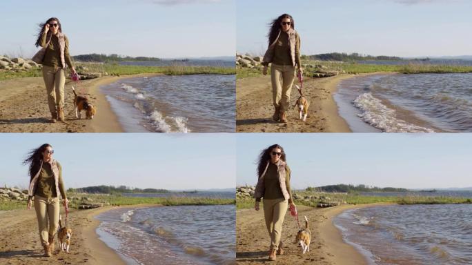 年轻女子喜欢和狗一起沿着湖岸散步