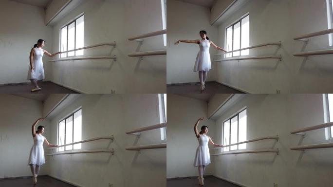 一名亚裔华裔女芭蕾舞演员在舞蹈室练习摔倒在地
