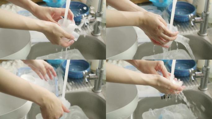 亚洲妇女为婴儿清洁一瓶牛奶