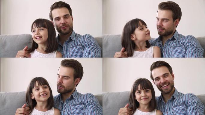 快乐的爸爸和小女儿与摄像机录音vlog交谈