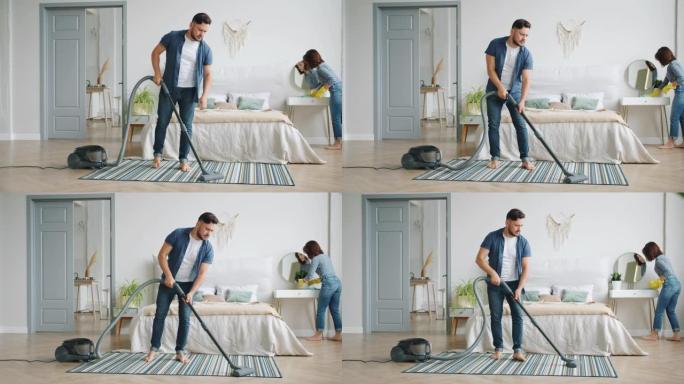 丈夫吸尘地毯妻子用湿布打扫家具做家务