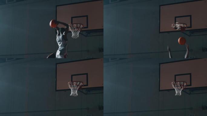 一名年轻的非洲职业男球员的电影慢动作镜头正在健身房进行篮球锻炼时扣篮