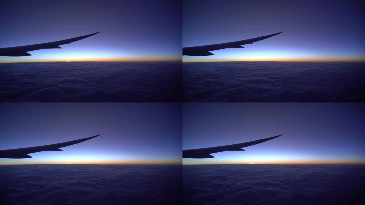 4k镜头日出时飞机在云层上空飞行的精彩场景，旅行和交通概念