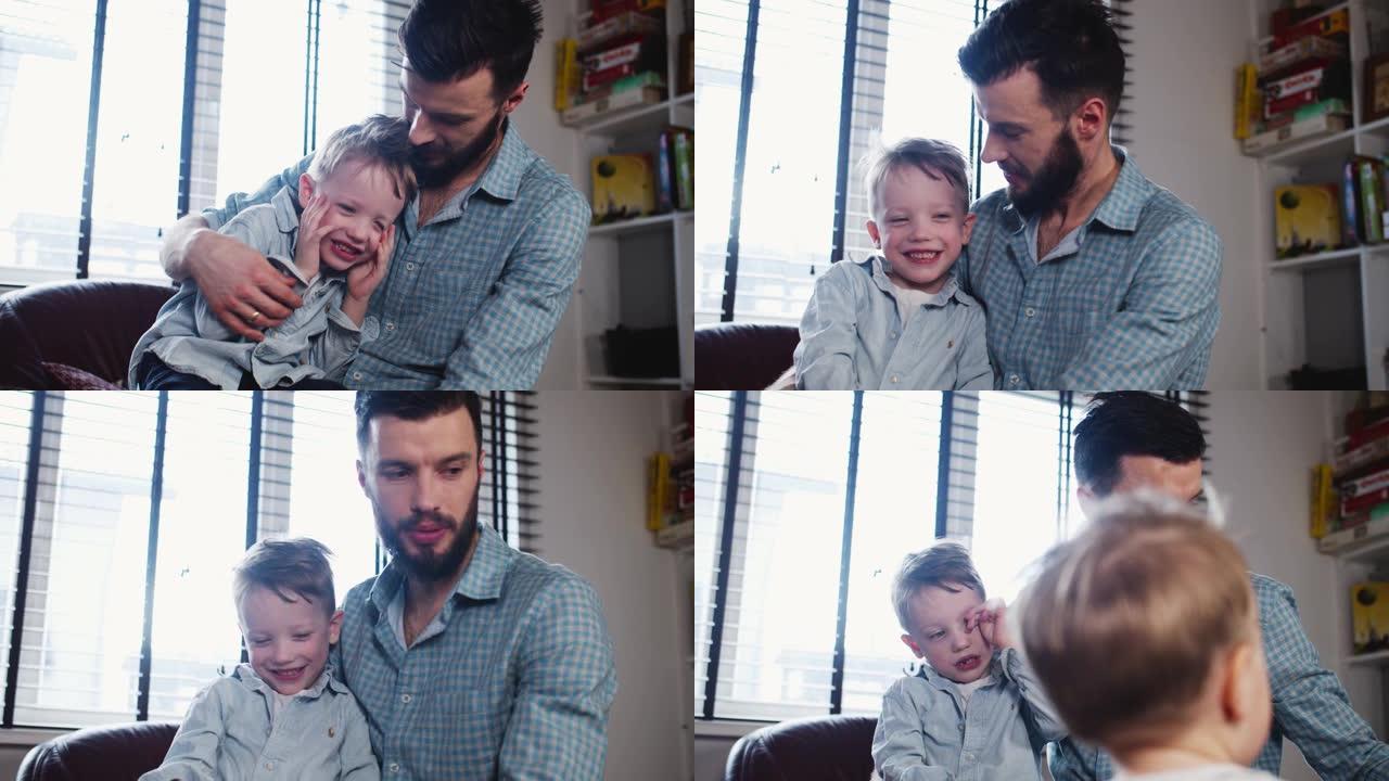 快乐的年轻高加索爸爸接吻的肖像，在现代灯光屋慢动作中与可爱的小微笑儿子玩耍。