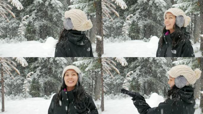 女人在冬天享受着新鲜的雪落在公园里