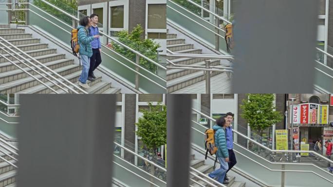 两个朋友在东京街头下车站楼梯的实时视频
