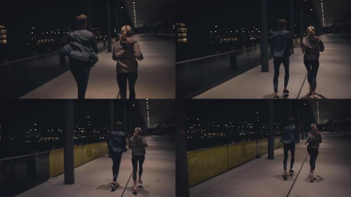 年轻夫妇在城市的高架人行道上奔跑