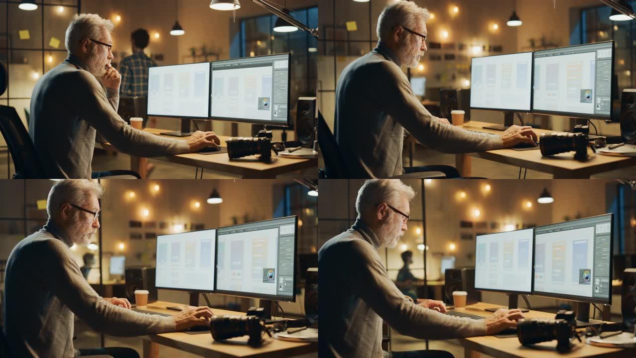 坐在办公桌前的创意中年移动软件设计师使用台式计算机，带有两个屏幕，显示智能手机应用程序的设计过程。时