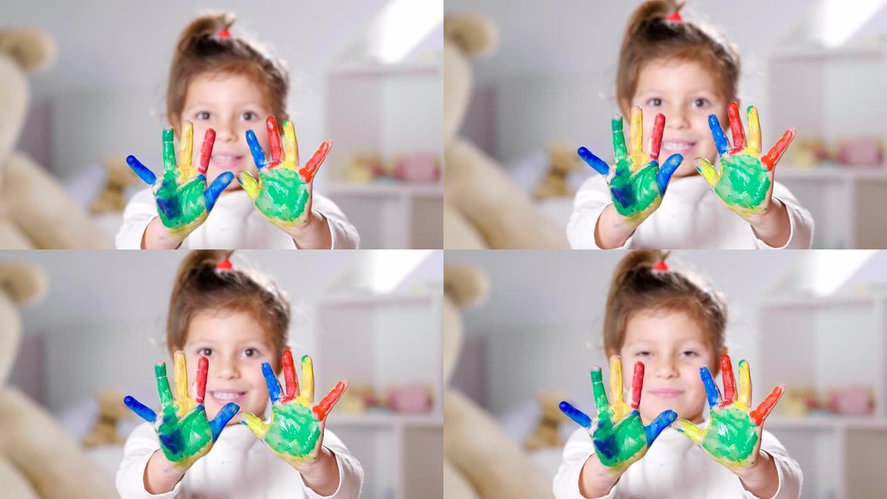 卧室里一个小女孩的肖像，显示她的手都被油漆着色。