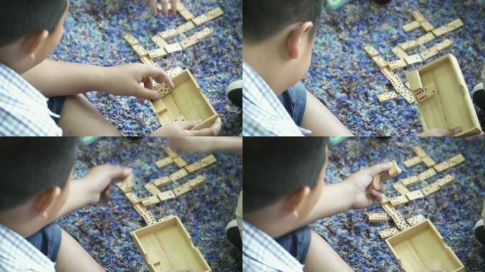 一个在家玩多米诺骨牌的男孩