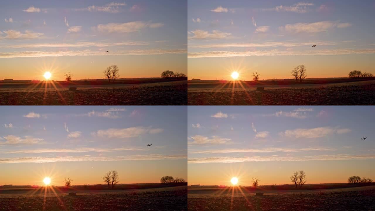 WS飞机在乡村田野上宁静的日落天空中上升