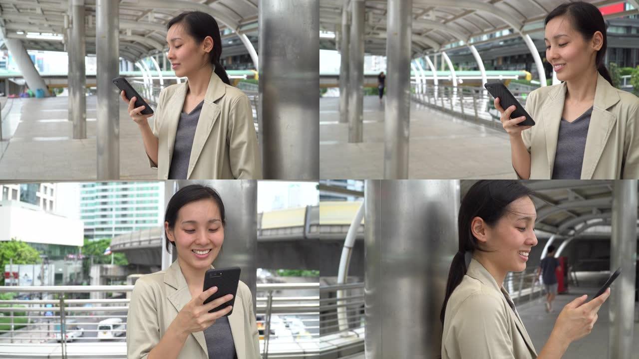 年轻的亚洲女性使用电话进行社交网络