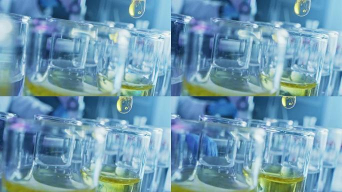 药剂学实验室: 移液器将黄色液体滴入试管，医学研究，分析。科学实验室; 滴管用创新的DNA研究溶液填