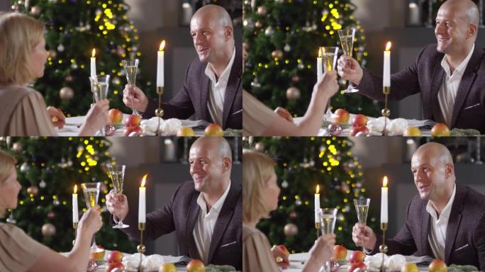 浪漫的白人男子在新年晚宴上为妻子敬酒