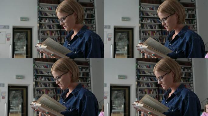 漂亮的女学生在图书馆看书，看起来很专注