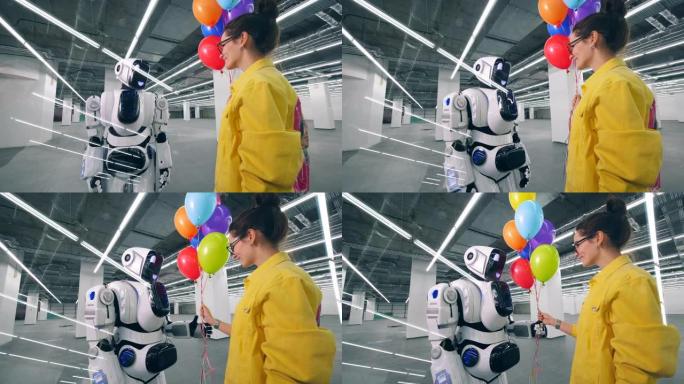 微笑的女士正在给机器人送彩色气球