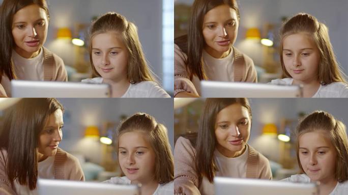 美女和女儿一起使用数字平板电脑