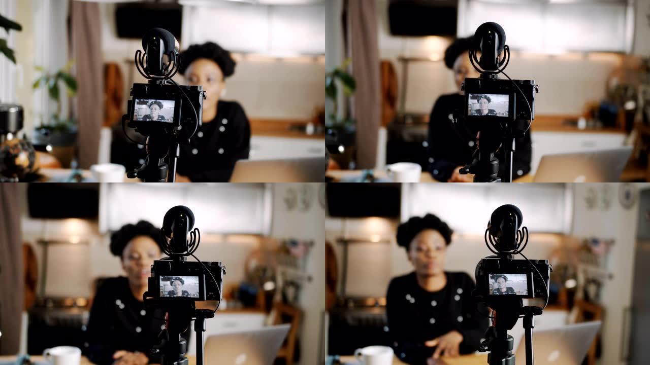 特写专业相机正在拍摄年轻美丽的非洲博主女人创造新的vlog视频慢动作。