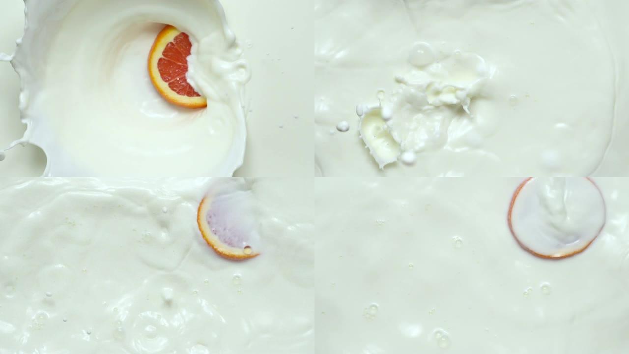 慢动作: 橙色切片落入牛奶中。